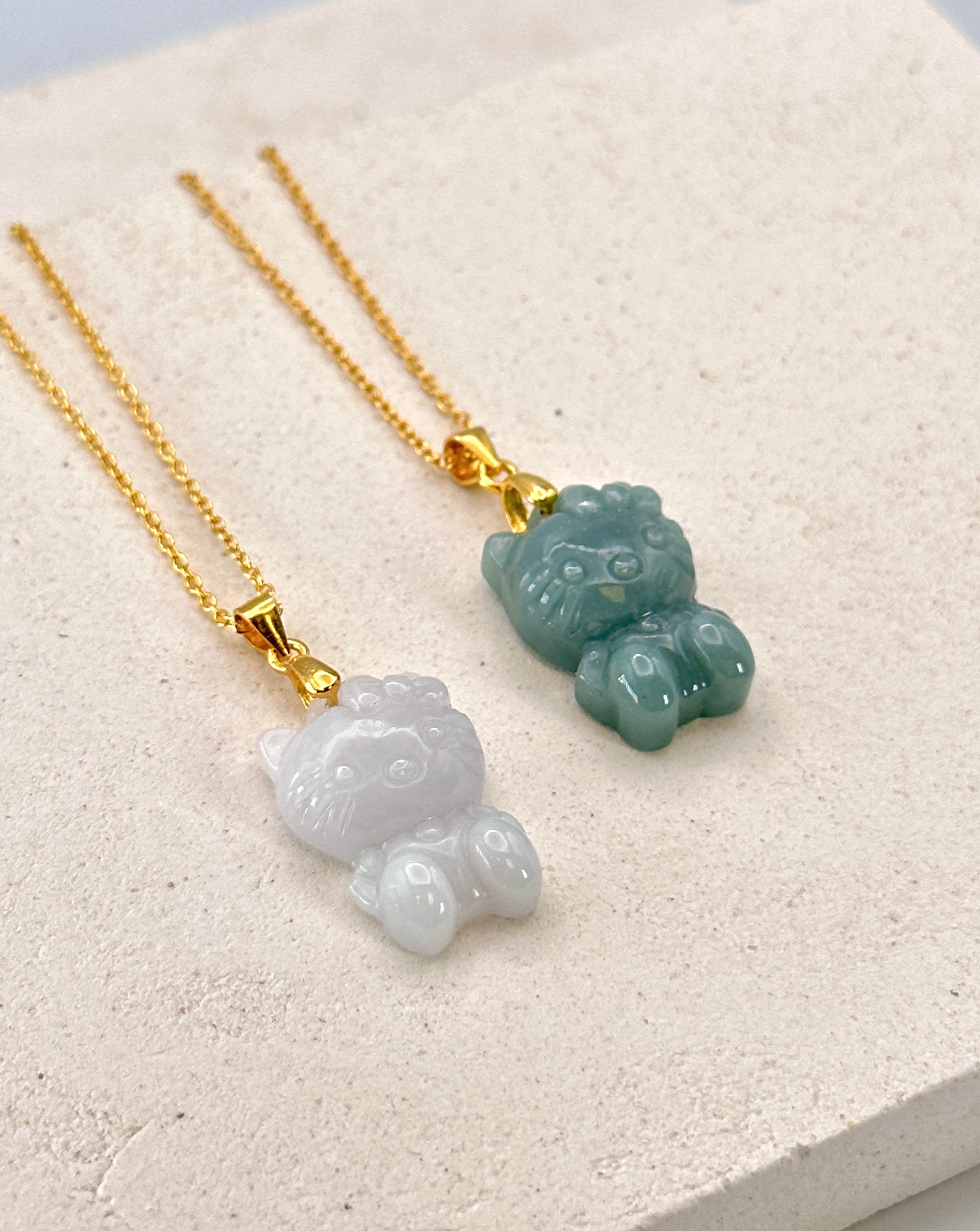 Hand-carved jade pendants on stone